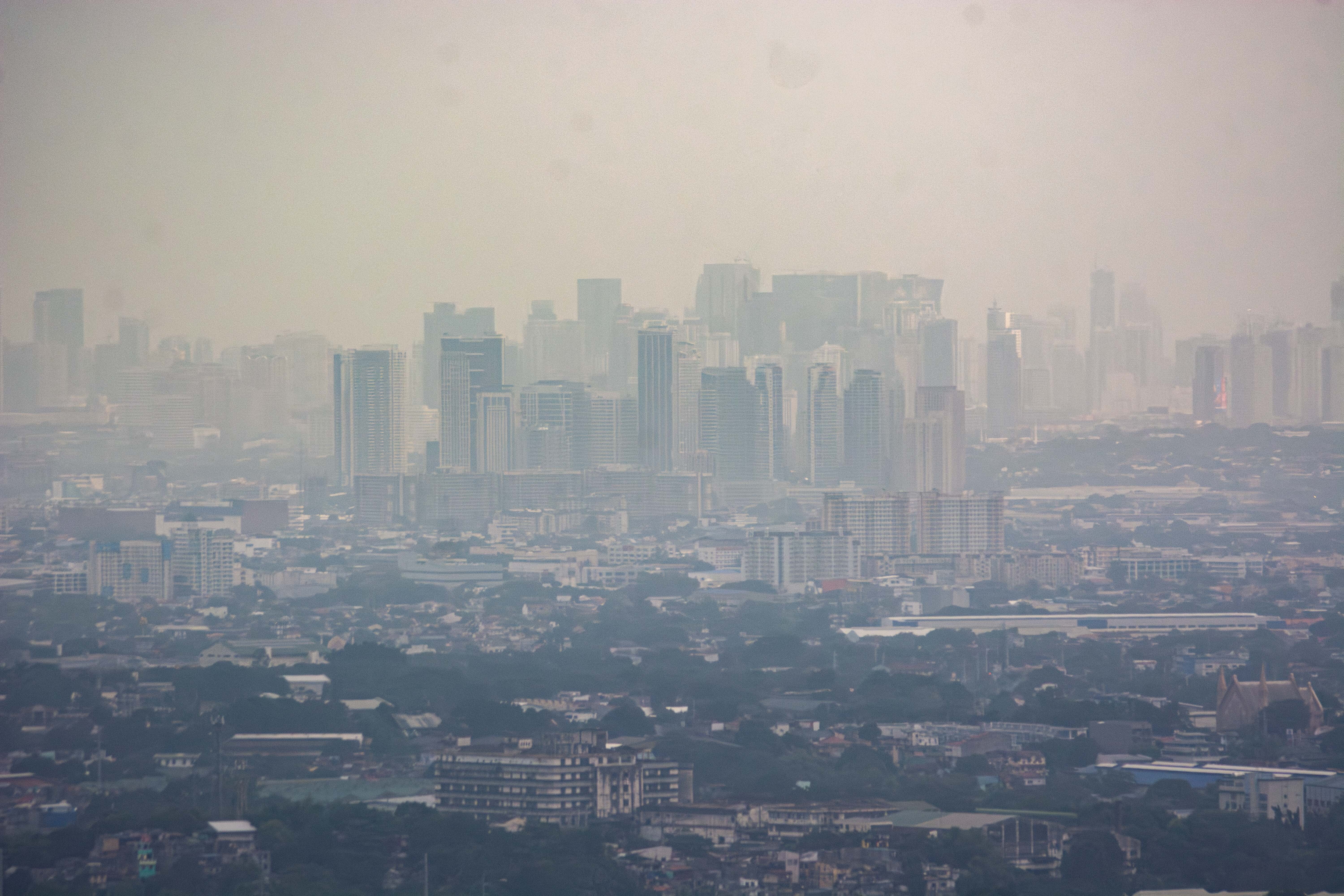 Smog mixed with a thick layer of clouds covers the Metro Manila skyline in the Philippines on Aug. 27.